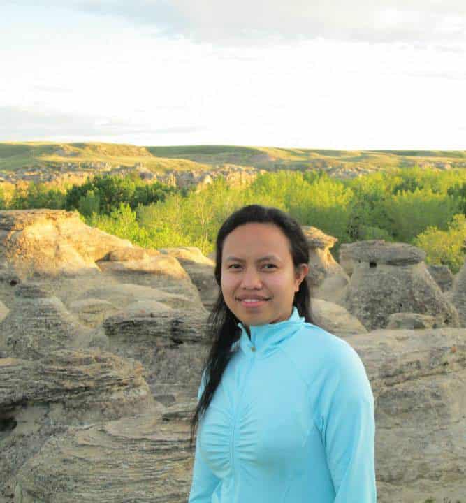 photo of woman wearing a turquoise sweater.