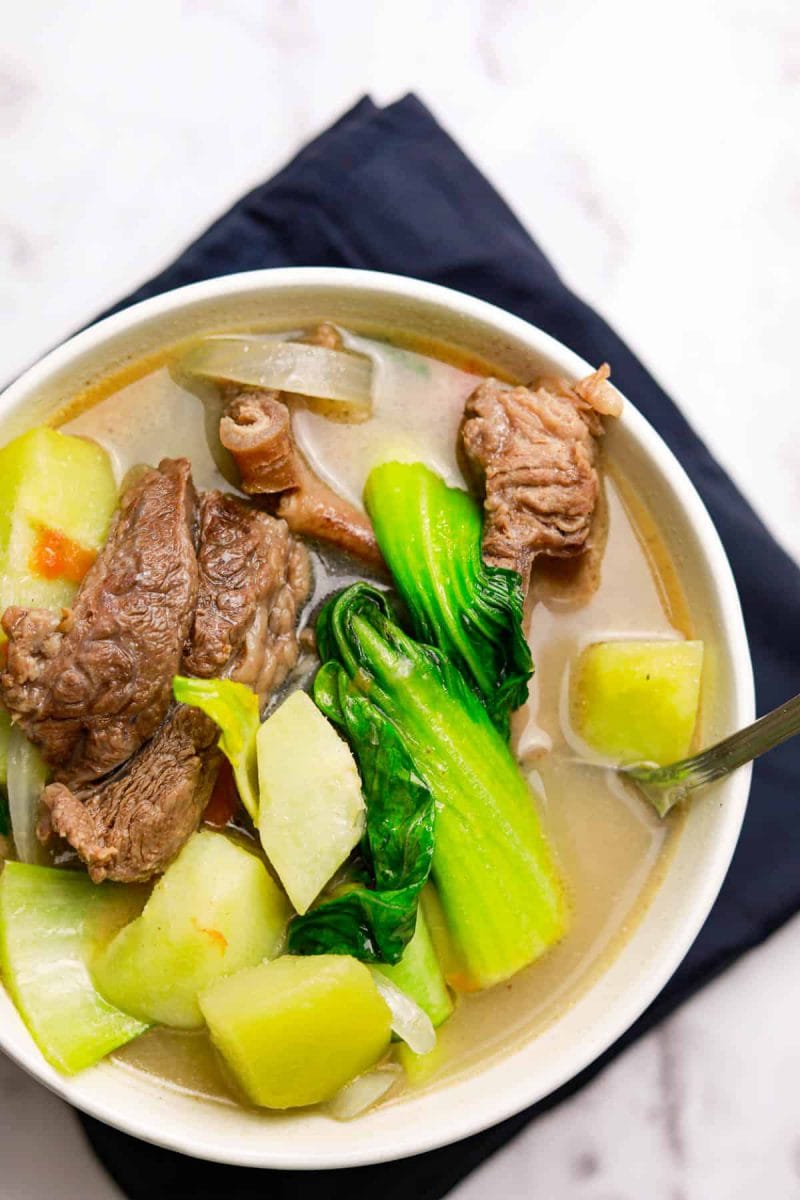 beef ribs sinigang with lemon juice in white bowl