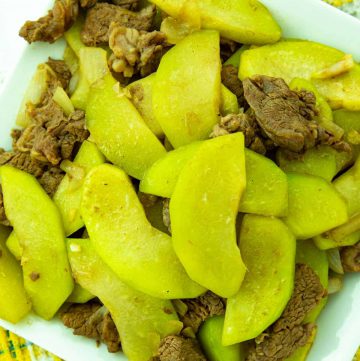 sautéed beef and chayote in a white plate