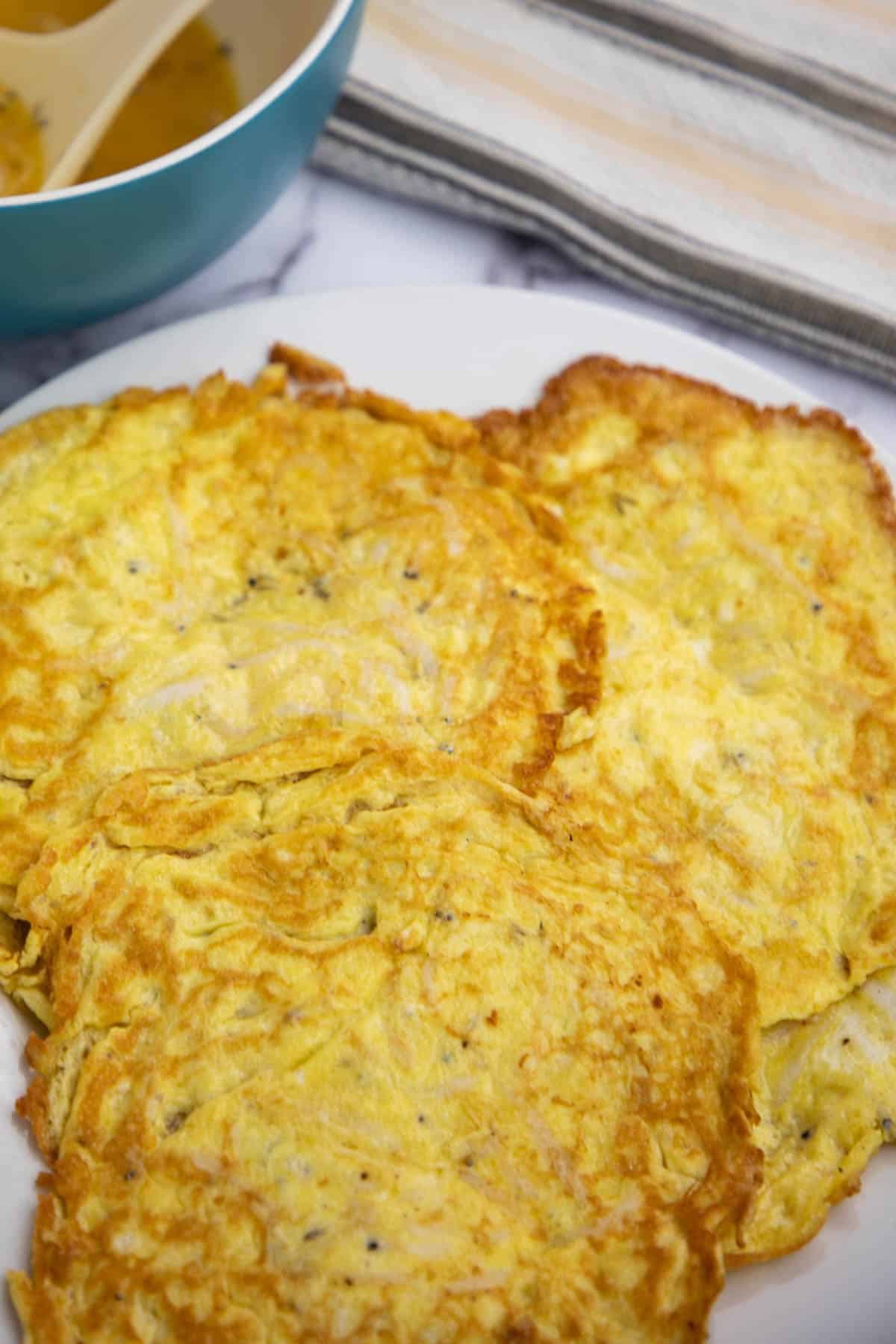 fish and egg omelet on white plate