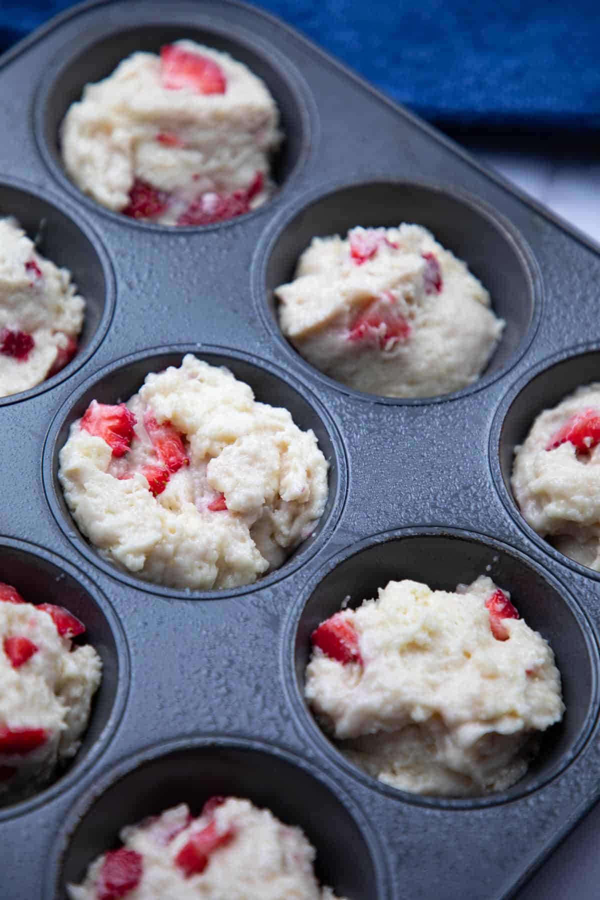 strawberry muffins batter on muffin tray