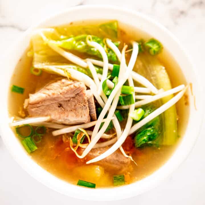 pork sour soup in white bowl with vegetables.