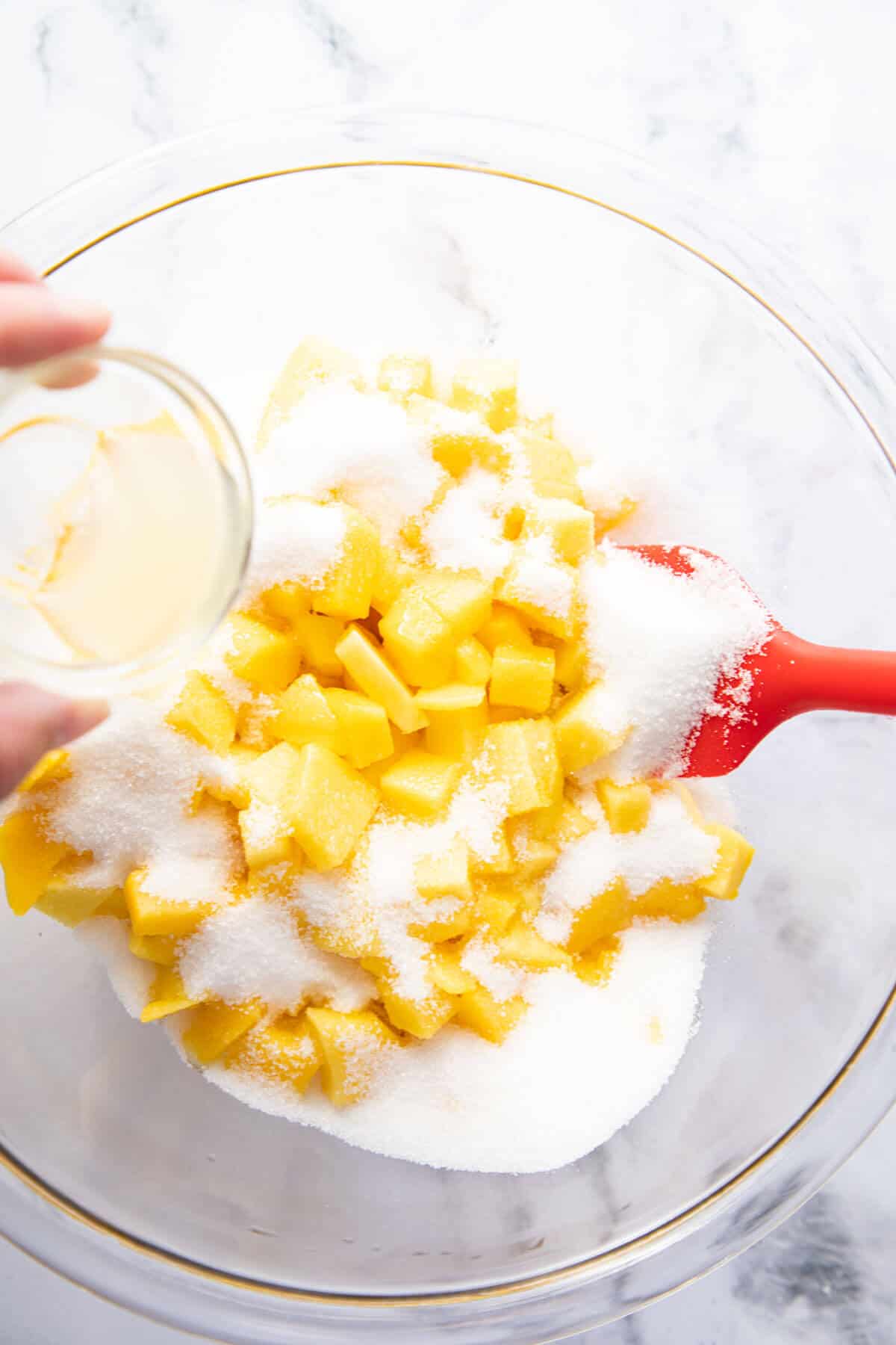 combine sugar,lemon juice, and mangoes in a clear bowl